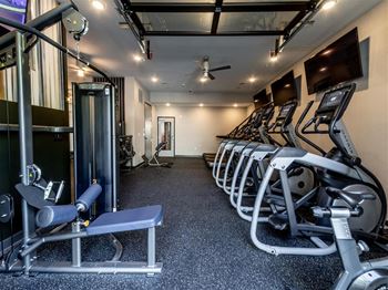 a gym with cardio equipment and weights on the floor at The Foundry, Indiana, 46617